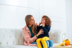 Mother comforting child with a toothache 